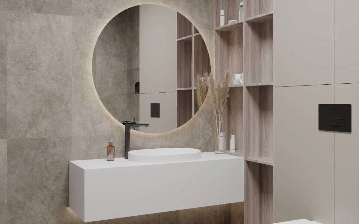 Close-up of bathroom vanity with round mirror, vessel sink, black faucet, and soft lighting
