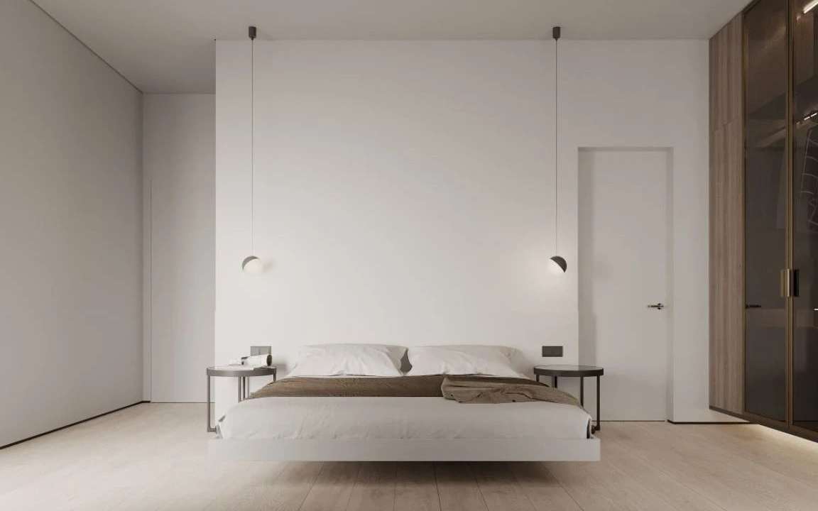 Front view of guest bedroom with floating bed, pendant lights, and round nightstands