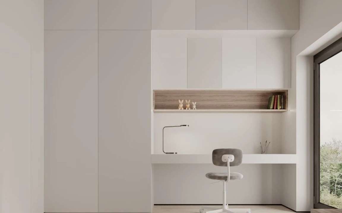 Minimalist study nook with built-in desk, overhead cabinets, and natural lighting