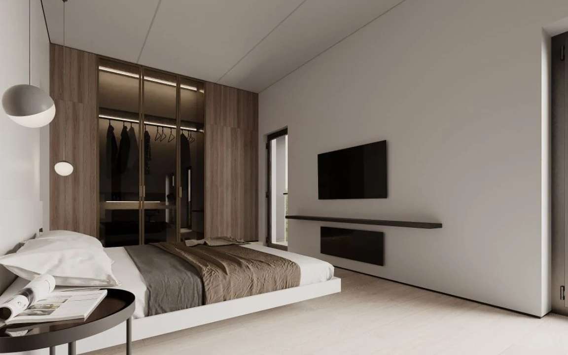 Bedroom with TV wall, floating bed, and built-in glass wardrobe with soft interior lighting