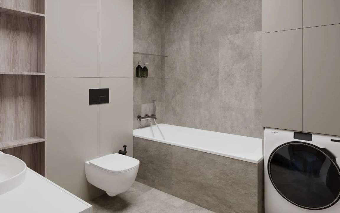 Guest bathroom with built-in bathtub, washer-dryer combo, and tall storage cabinetry