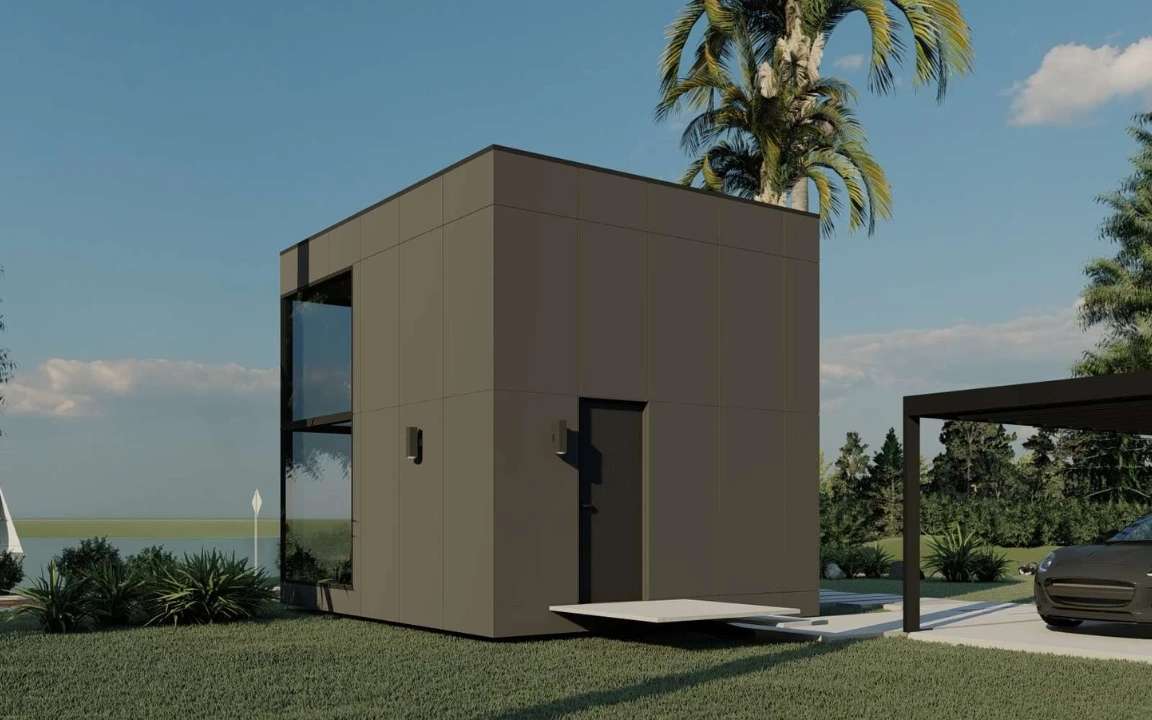 Side view of the  modular house showing the black exterior and front entrance