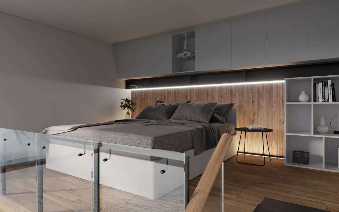 Loft bedroom in the  modular house with glass railing and projector setup