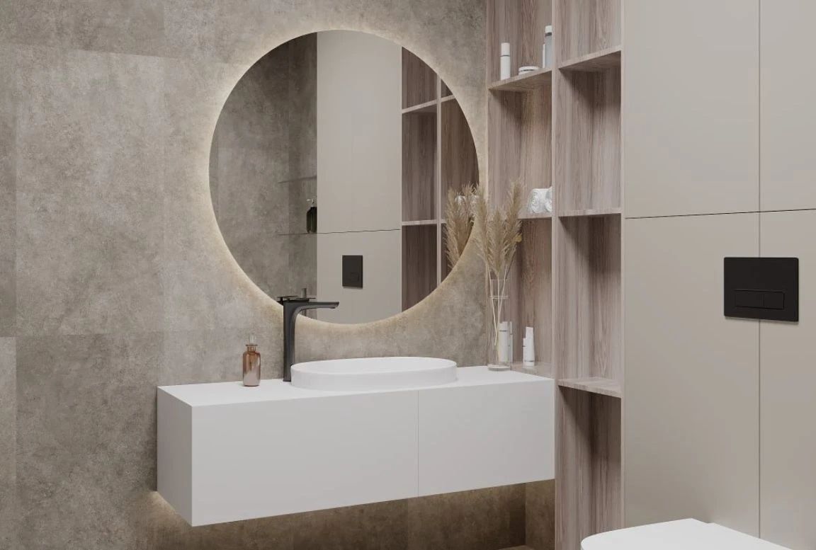 Close-up of bathroom vanity with round mirror, vessel sink, black faucet, and soft lighting