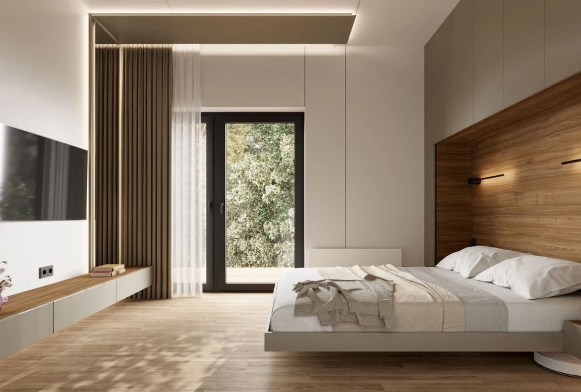 Modern minimalist bedroom featuring a floating bed with wood accent wall, built-in lighting, and a large window overlooking greenery.