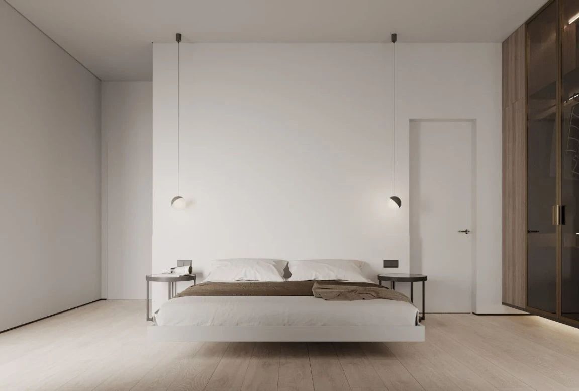Front view of guest bedroom with floating bed, pendant lights, and round nightstands