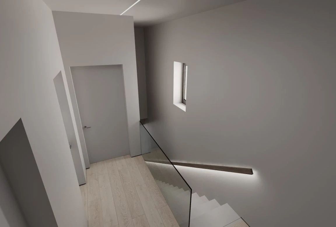 Minimalist stairwell with glass balustrade, ambient lighting, and narrow window