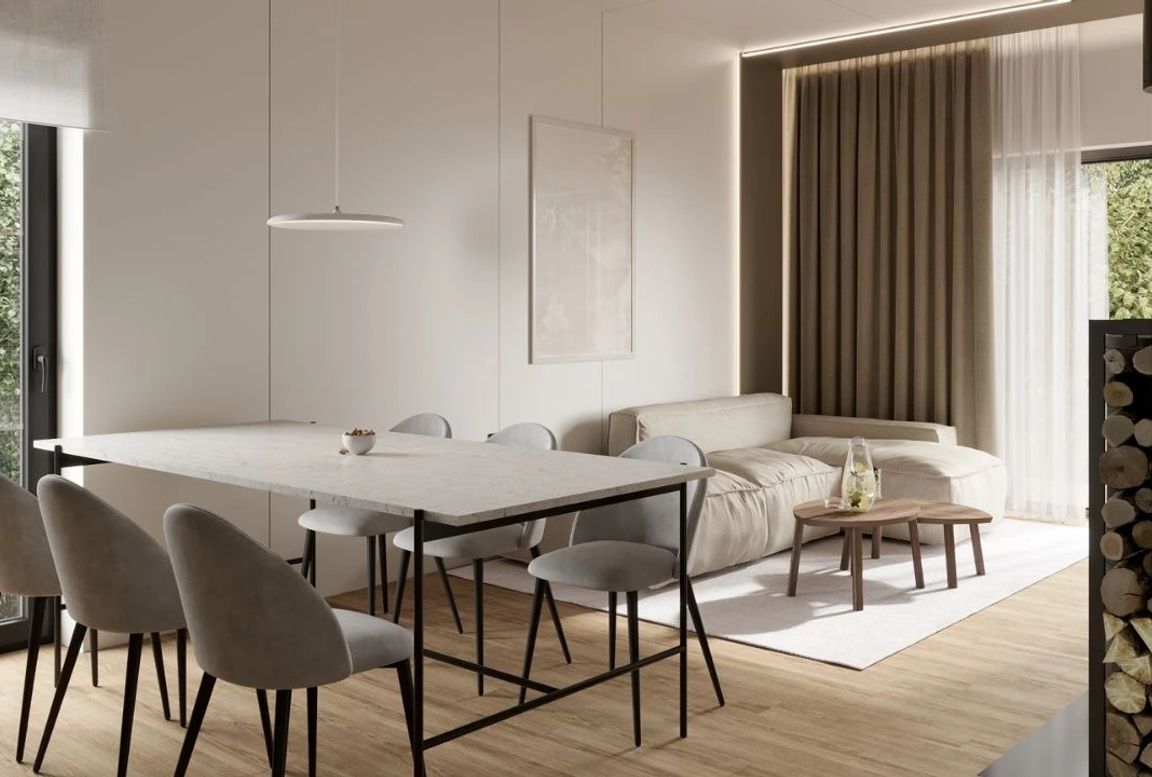 Bright open-plan dining and living room with soft neutral tones and natural light