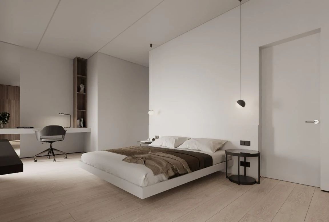 Guest bedroom with floating bed, wall desk, warm tones, and pendant lighting