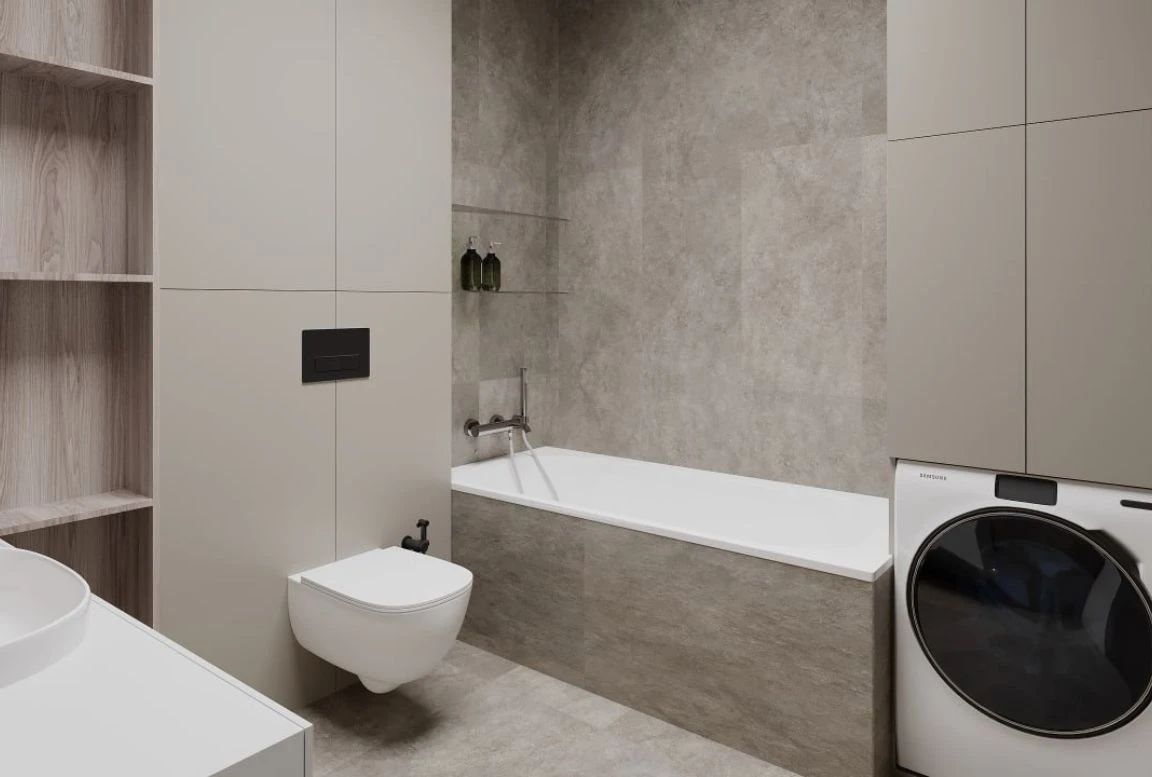 Guest bathroom with built-in bathtub, washer-dryer combo, and tall storage cabinetry