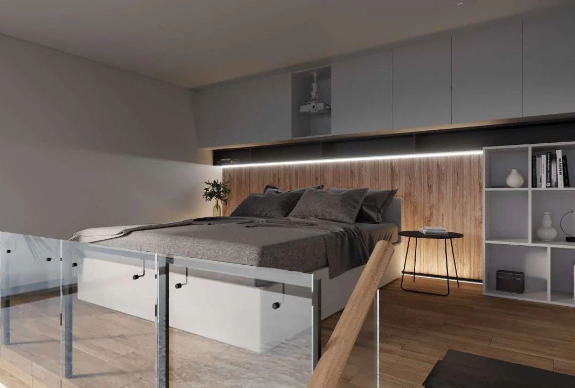 Loft bedroom in the  modular house with glass railing and projector setup